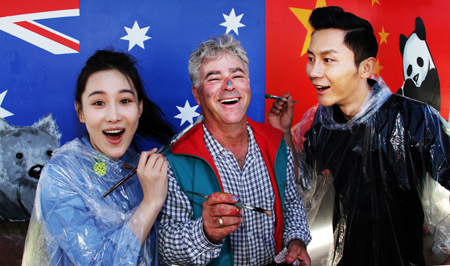A-list Chinese celebrities actors   Zhang Xin Yu (left) (whose stage name is Viann) and  Li Chen (Right) proved to be dab hands at  painting a mural in Sheffield yesterday with help from local artist Julian Bale.